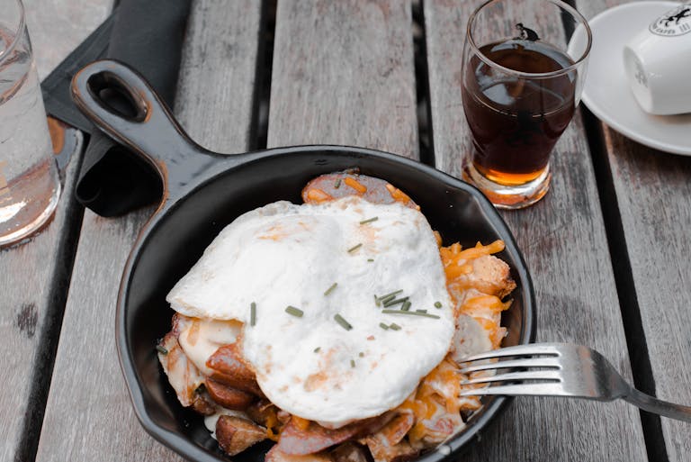 Close-up of a delicious rustic breakfast with fried eggs in a skillet.