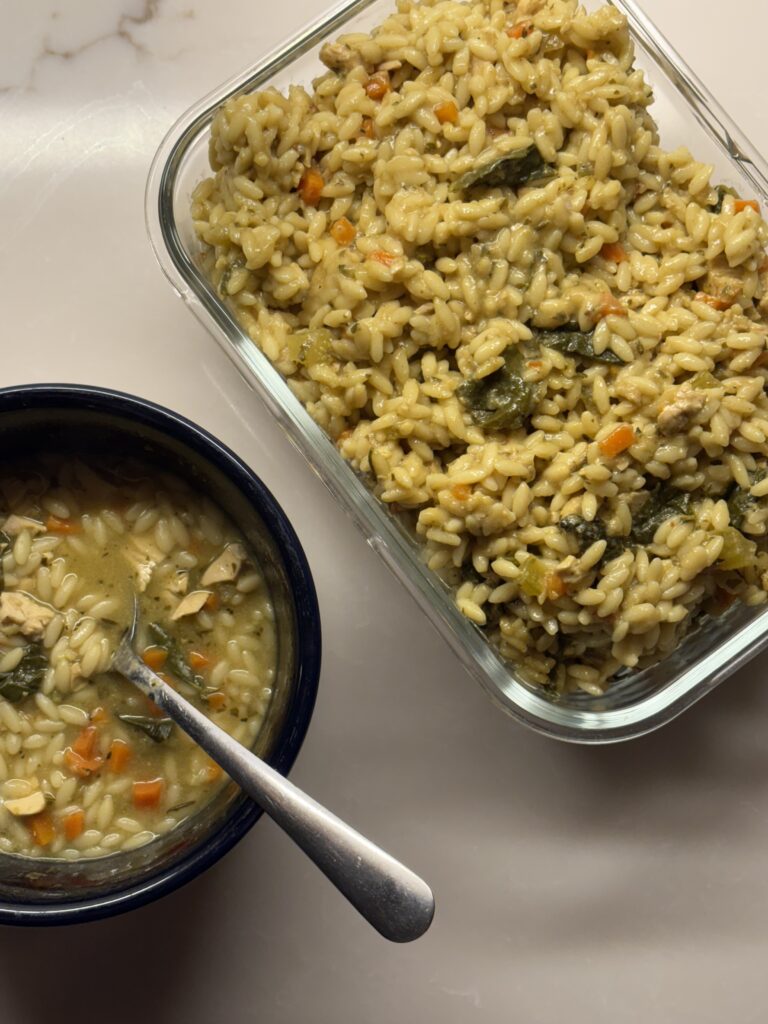 A Bowl And A Glass Meal Prep Container Of Chicken And Orzo 